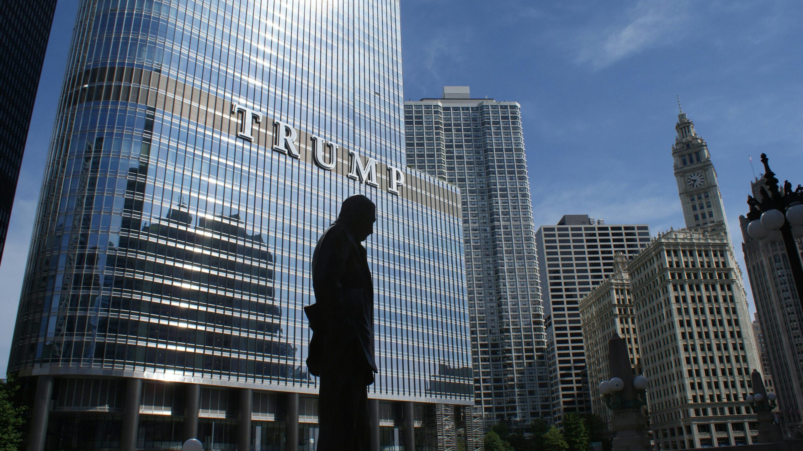 silhouette of man standing in front of Trump tower